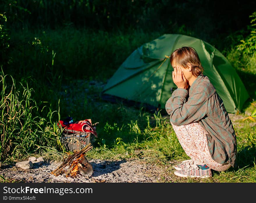 Morning in the woods, outdoor activities, woman makes a fire