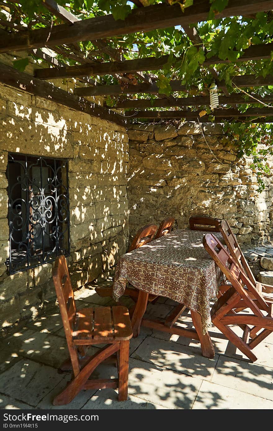 Old fashioned Cafe terrace with tables, chairs and trees, outdoors