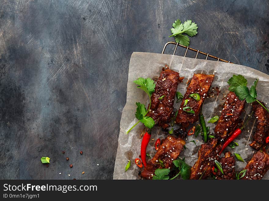 Roasted pork ribs with spicy sauce, copy space