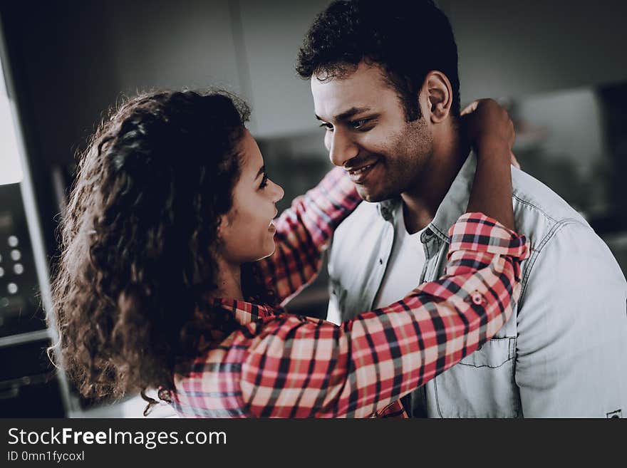 Afro American Couple Is Hanging In Kitchen. Weekend Concept. Holiday Resting. Smiling Together. Having Fun. Romantic Date. Cheerful Sweethearts. Staring At Each Other. Happy Family. Afro American Couple Is Hanging In Kitchen. Weekend Concept. Holiday Resting. Smiling Together. Having Fun. Romantic Date. Cheerful Sweethearts. Staring At Each Other. Happy Family.