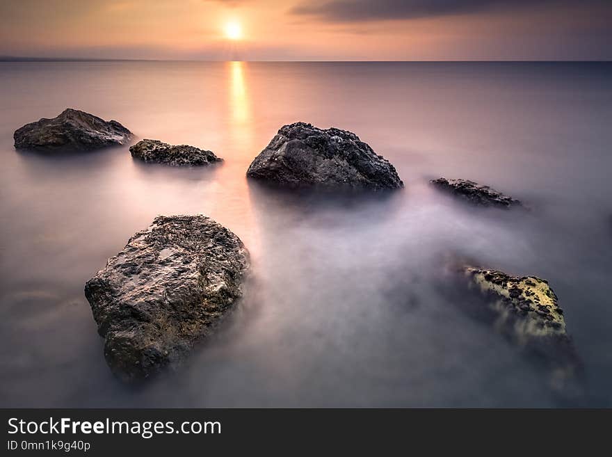 Rocks on the beach at sunrise