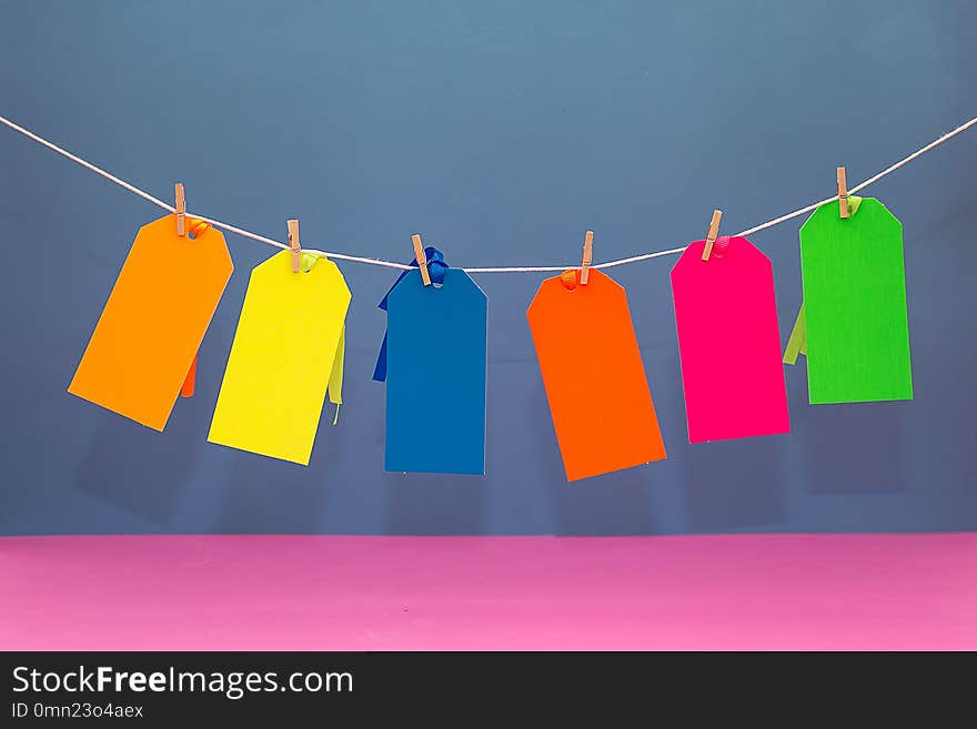 Six Colorful Paperboard Tags Hanging on a String. Six Colorful Paperboard Tags Hanging on a String