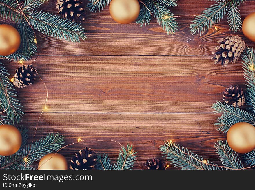 Brown wooden background with festive Christmas decoration, copy space