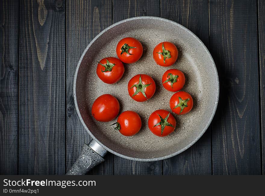 Ripe, fresh tomatoes on dark rustic wooden background. Organic, healthy, raw, vegetarian food. Ripe, fresh tomatoes on dark rustic wooden background. Organic, healthy, raw, vegetarian food.