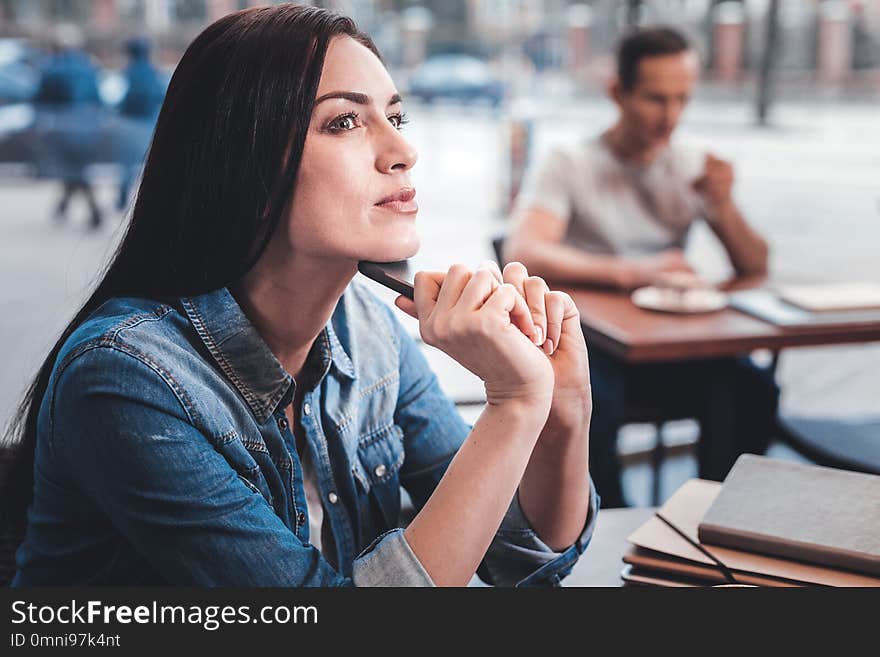 Favorite place. Charming female person sitting in semi position and being deep in thoughts. Favorite place. Charming female person sitting in semi position and being deep in thoughts