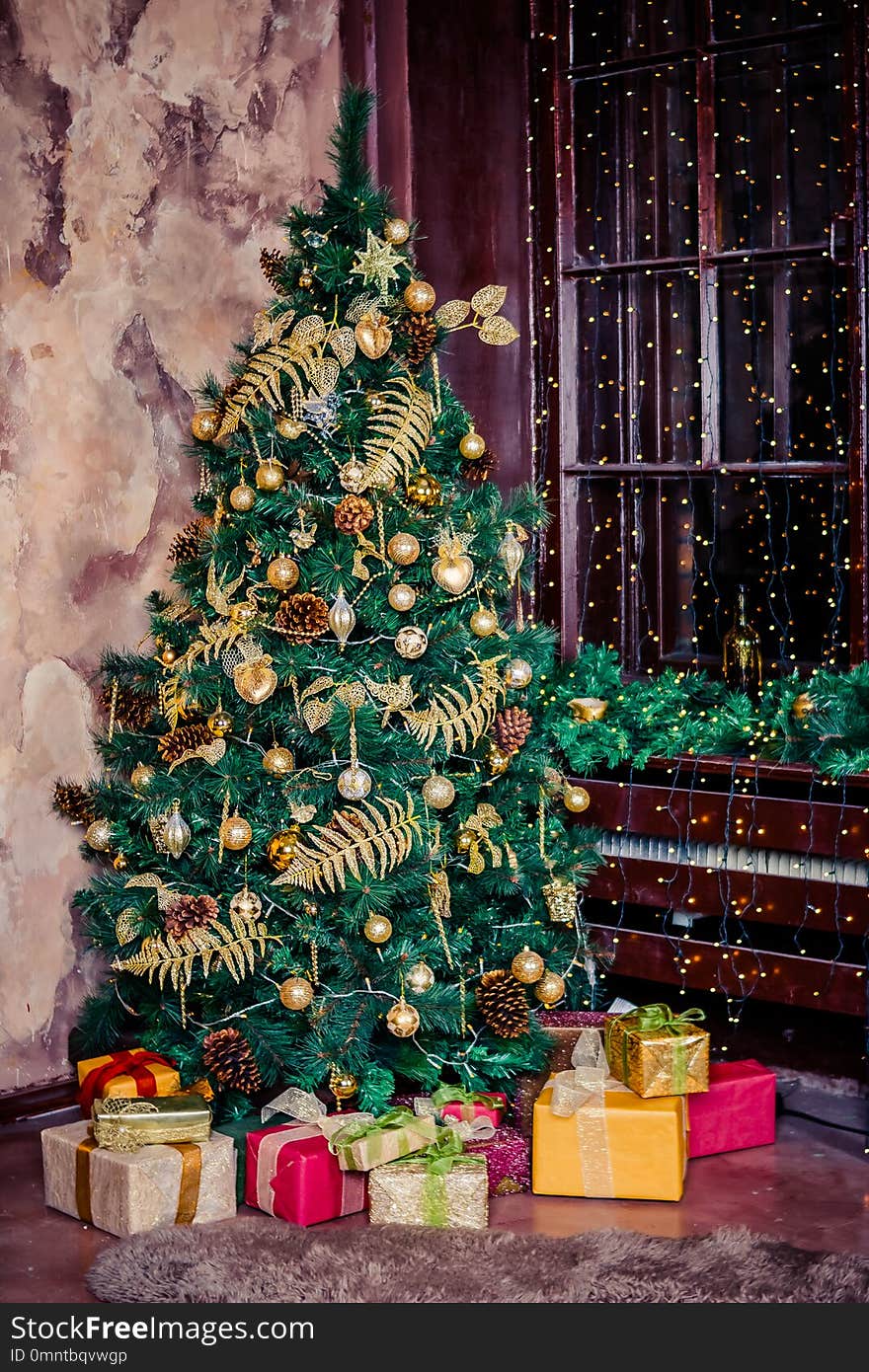 Festively decorated home interior with Christmas tree.gift boxes under the Christmas tree. Colorful yellow and red