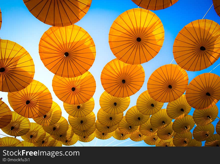 Pattern Yellow Umbrellas On Blue Sky.