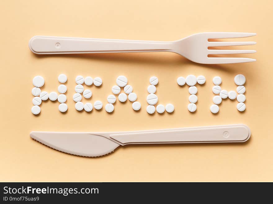 The inscription of the tablets with a knife and fork. Healthy eating concept