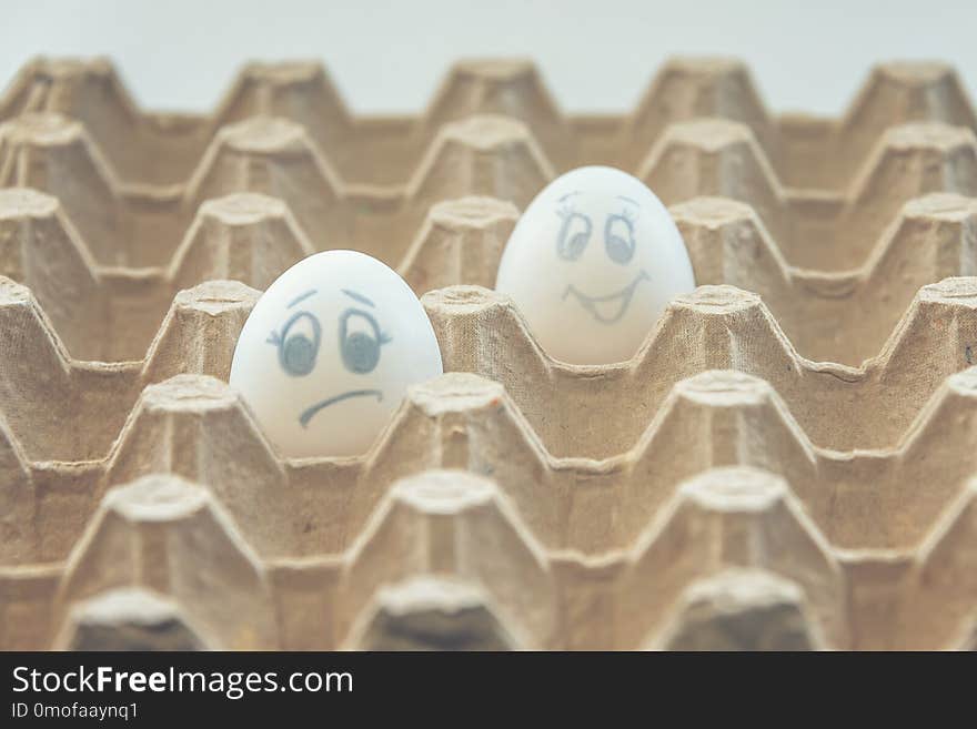 White chicken eggs with painted faces. White chicken eggs with painted faces