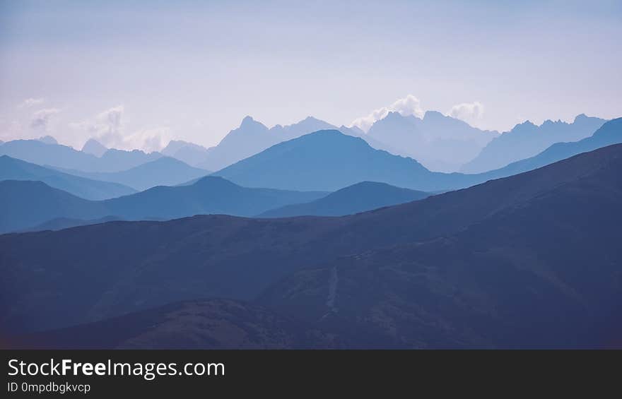 western carpathian mountain tops in autumn covered in mist or clouds with blue cast and multidimensional lines - vintage retro look - vintage color look. western carpathian mountain tops in autumn covered in mist or clouds with blue cast and multidimensional lines - vintage retro look - vintage color look