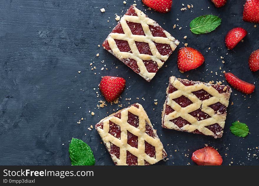 Strawberry cookies with strawberry fruits on dark background.