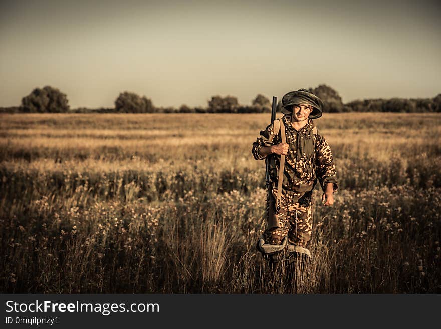 Hunting hunter going rural plain field golden sunset during hunting season vintage