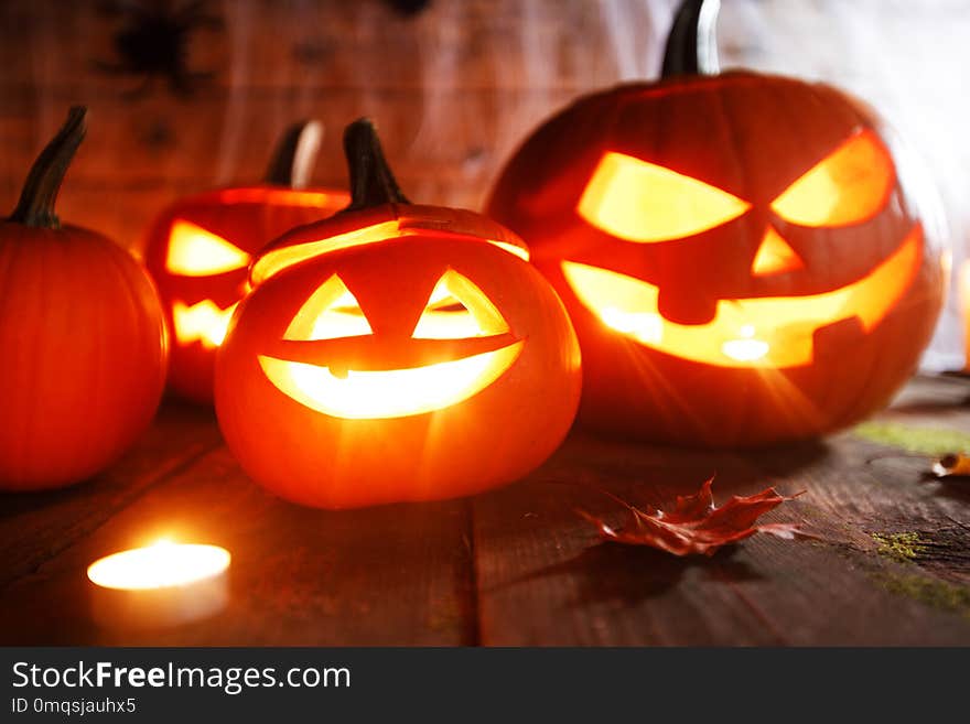 Jack O Lantern Halloween pumpkin, spiders on web and burning candles. Jack O Lantern Halloween pumpkin, spiders on web and burning candles