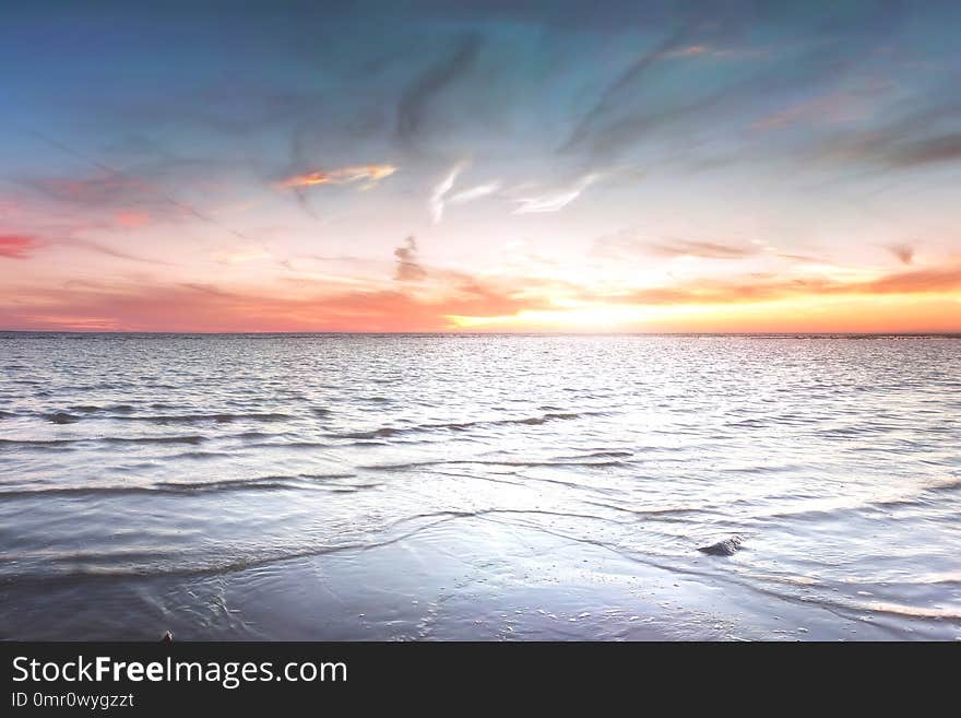 Sandy beach with rocks and foaming. Estonia