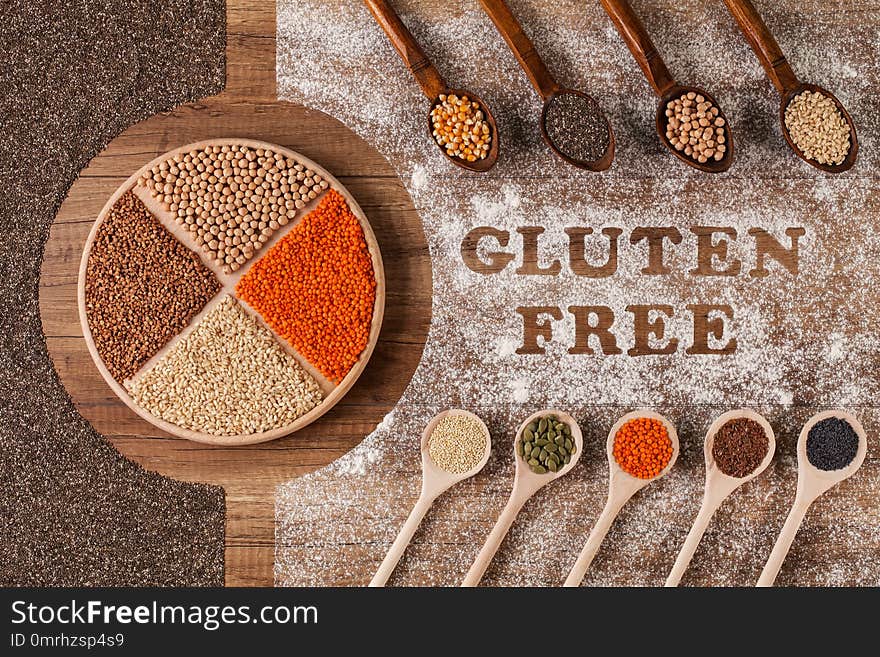 Gluten free food choices - various grains and seeds in wooden spoons, top view. Gluten free food choices - various grains and seeds in wooden spoons, top view