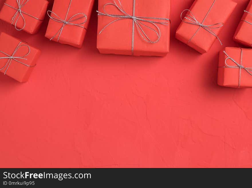 The row of presents wrapped in red craft paper