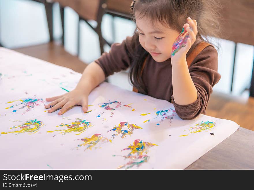 Kids with dirty painted hand in art classroom