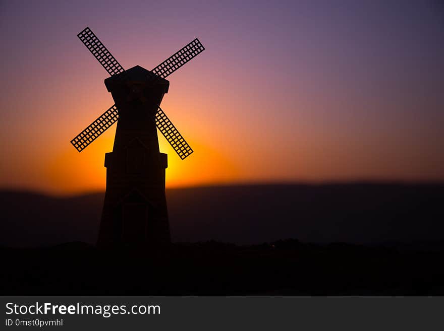 Traditional, Dutch windmill at a hill during a summer sunset. Decoration.