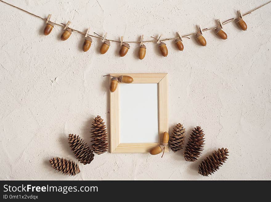 Autumn composition. Acorn with clothespins on clothes line rope. Wooden pegs. Flat lay, top view, copy space. Autumn composition. Acorn with clothespins on clothes line rope. Wooden pegs. Flat lay, top view, copy space