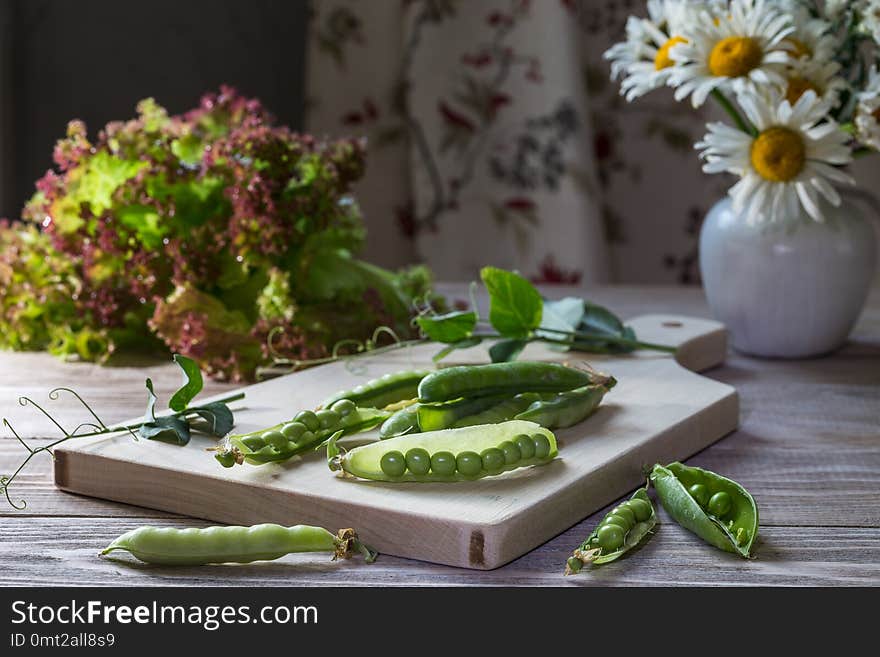 Fresh green peas on a wooden table. Fresh green peas on a wooden table.