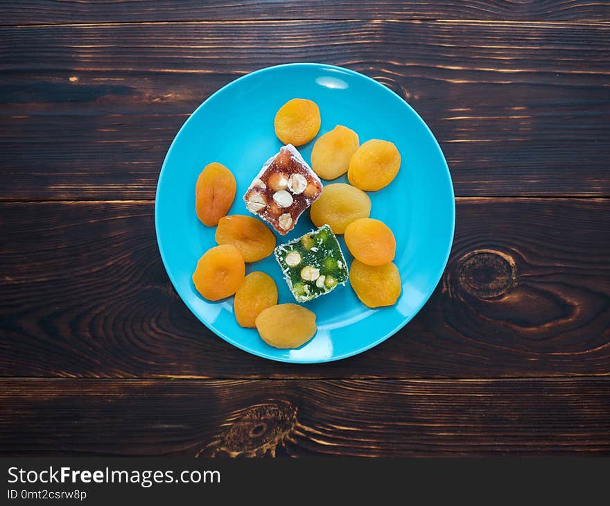 Natural Eastern sweets rahatlukum and dried apricots on a beautiful plate