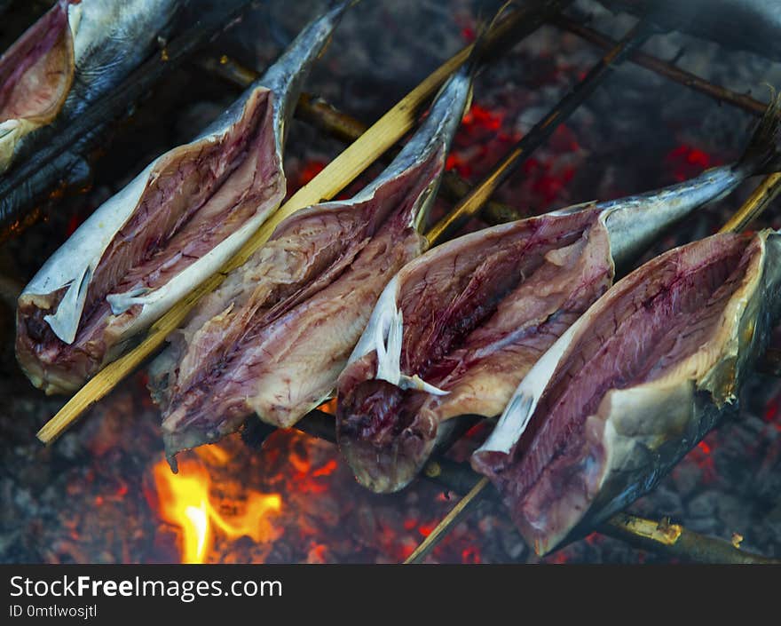 Roasting fish on fire closeup