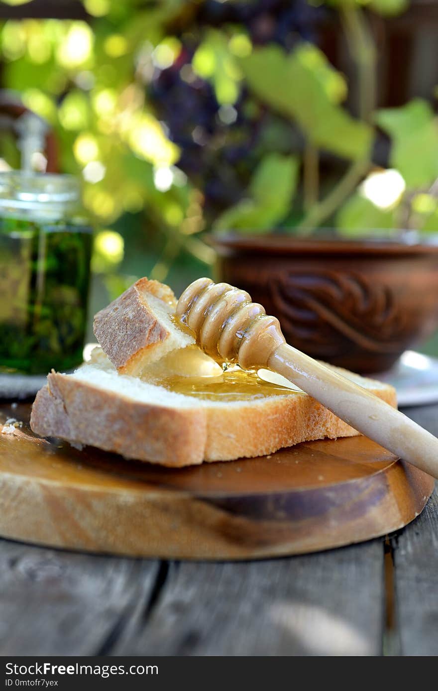 Still life with honey, grapes and white bread