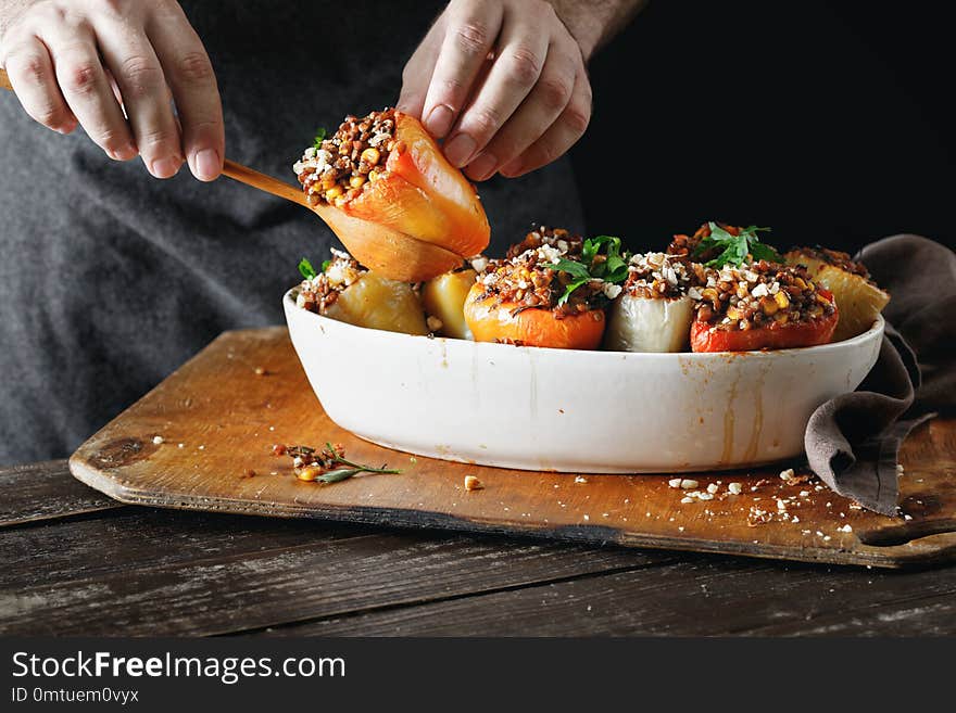 Male hands holding cooked stuffed peppers Healthy vegetarian foo