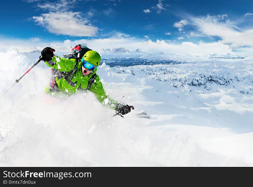 Alpine freeride skier skiing downhill with powder snow explosion. Winter sports and leasure activities. Alpine freeride skier skiing downhill with powder snow explosion. Winter sports and leasure activities