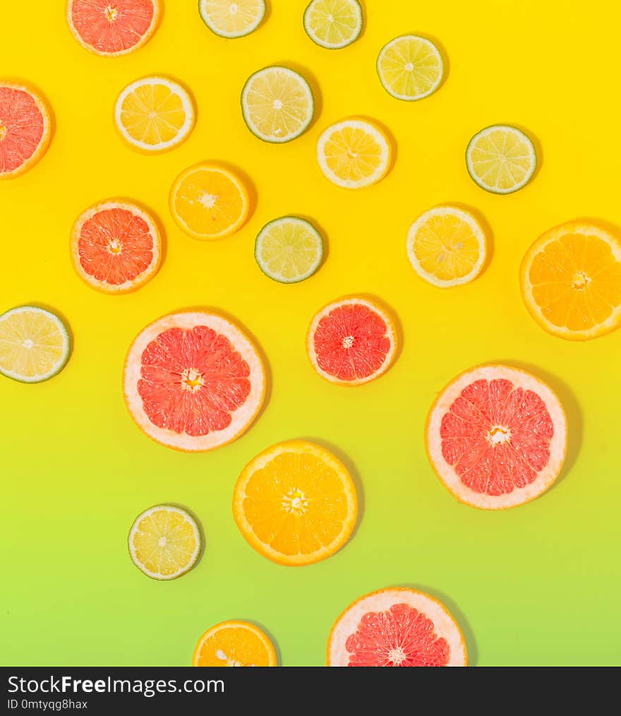 Flat lay summer background. Top view of sliced citrus fruit