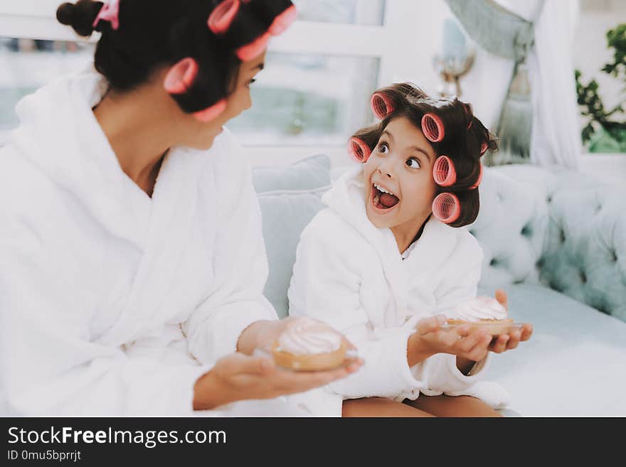 Little Lady with Curlers. Mother and Daughter in Spa. Girl and Mom with Cake. Beautiful Little Lady. Beautiful Face. Woman and Happy Child. Woman with Curlers. Smiling Person. Blue Sofa in Spa Salon. Little Lady with Curlers. Mother and Daughter in Spa. Girl and Mom with Cake. Beautiful Little Lady. Beautiful Face. Woman and Happy Child. Woman with Curlers. Smiling Person. Blue Sofa in Spa Salon.