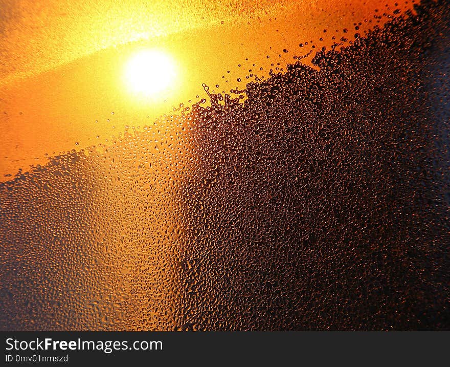 Nature Background With Bright Sunlight, Water Drops And Ice Pattern On Glass