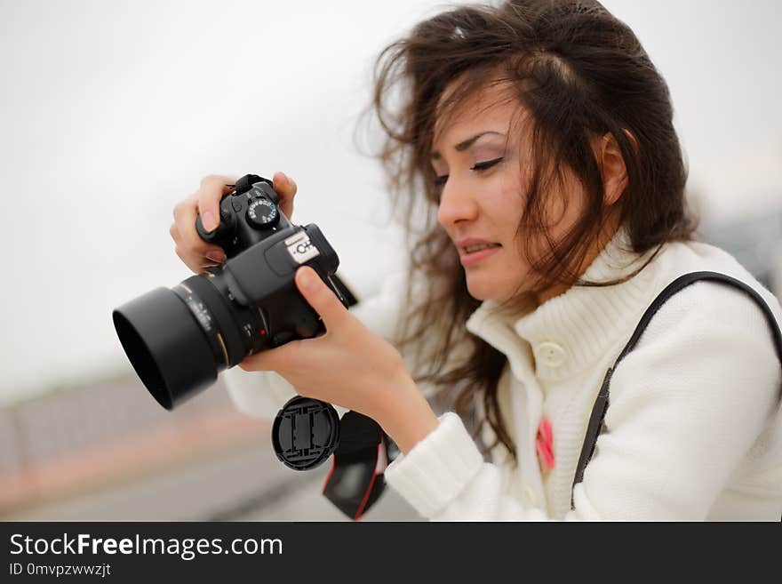 Woman photographer taking picture. Photo hobby