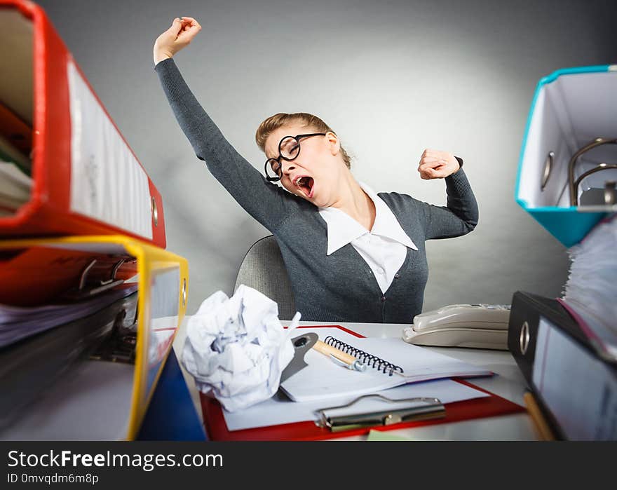 Boredom and fatigue concept. Young emotional expressive woman in office. Bored tired businesswoman yawning stretching at work. Boredom and fatigue concept. Young emotional expressive woman in office. Bored tired businesswoman yawning stretching at work.