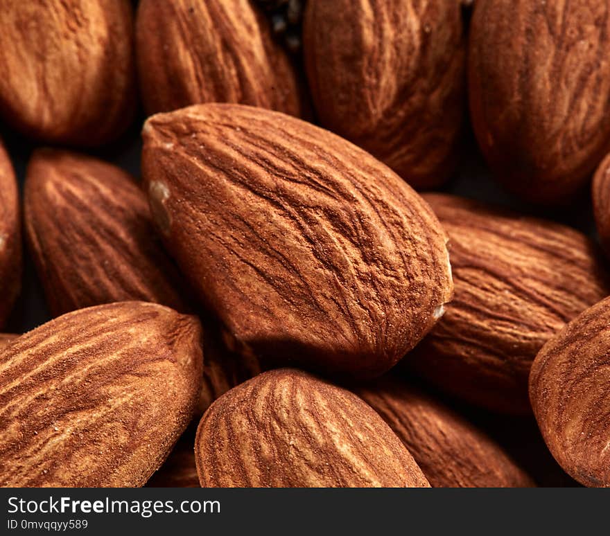 Organic texture of almonds. View from above. Almonds macro background. Almond nuts with soft focus.