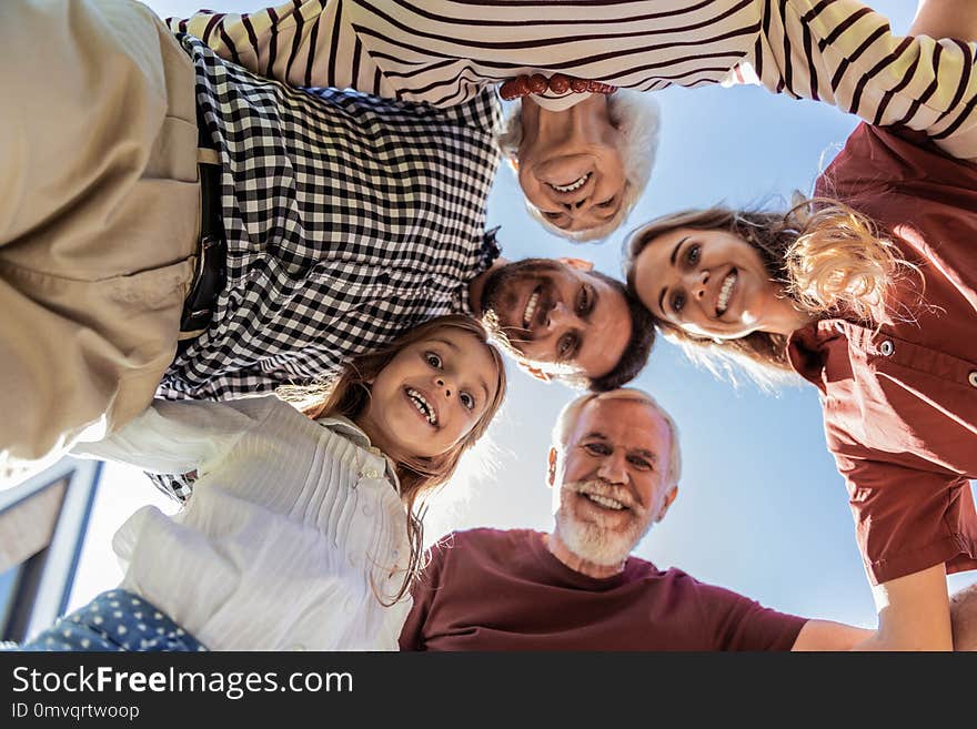 Gather at time. Delighted brunette bearded men keeping smile on his face while looking downwards. Gather at time. Delighted brunette bearded men keeping smile on his face while looking downwards