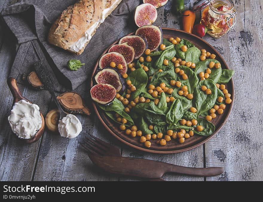 Chickpea, spinach leaves and figs vegetarian salad, cream cheese, healthy homemade vegan food, diet.