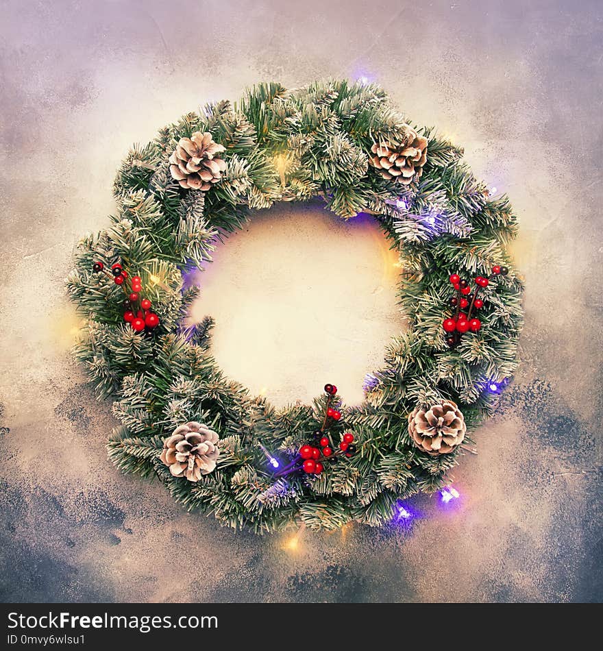 Christmas or New Year frame flat composition with green snow fir branches in wreath, pine cones, golden snowflakes, Christmas balls, red berries on gray background, top view
