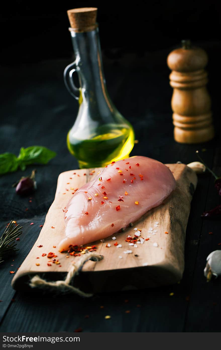 Raw Chicken Fillet With Spices And On A Dark Background