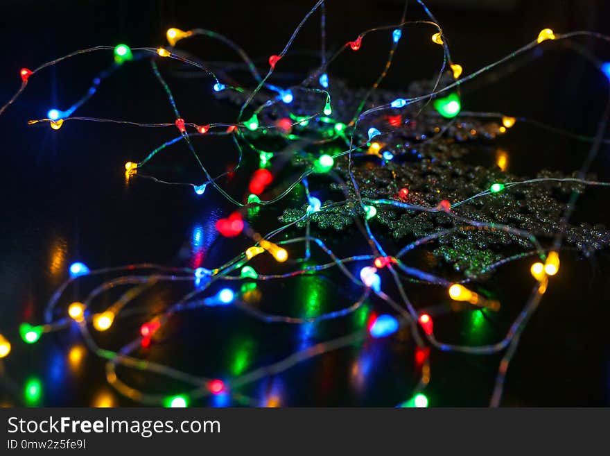 New Year Garland With Little Lamps On Black Background With Snowflake