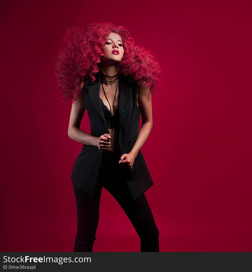 Wow girl with unbelievable lush hair. Portrait of beautiful young woman with red hair on red background