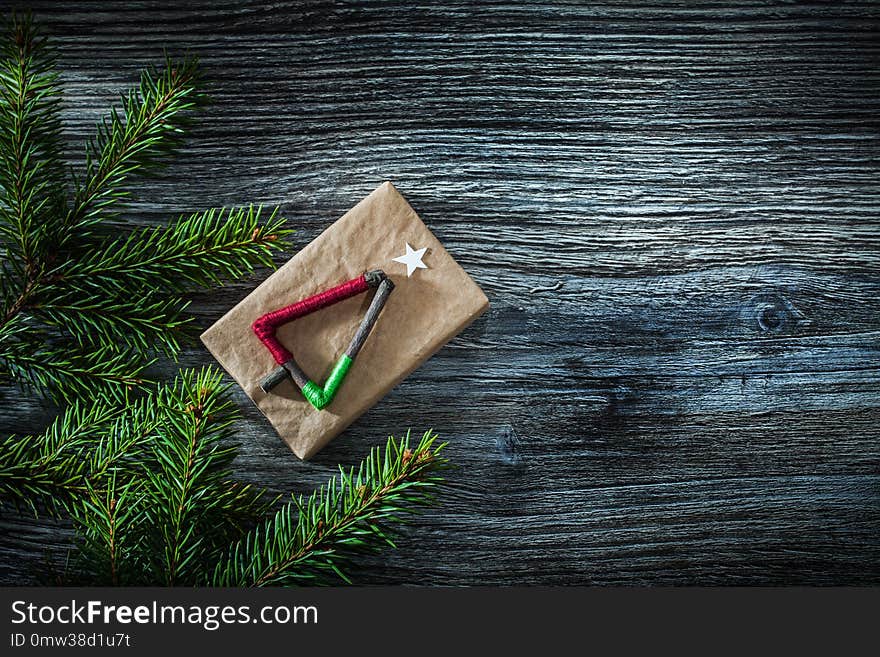 Pine tree branches gift box on wooden board.