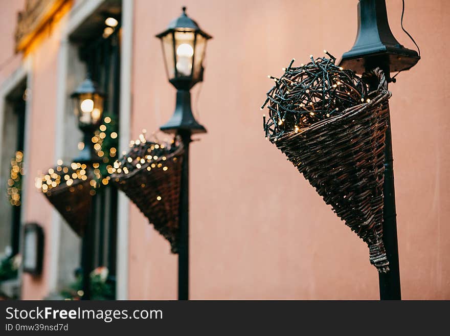 Traditional Christmas decorations in the street in Warsaw. Decorated lampposts with garlands