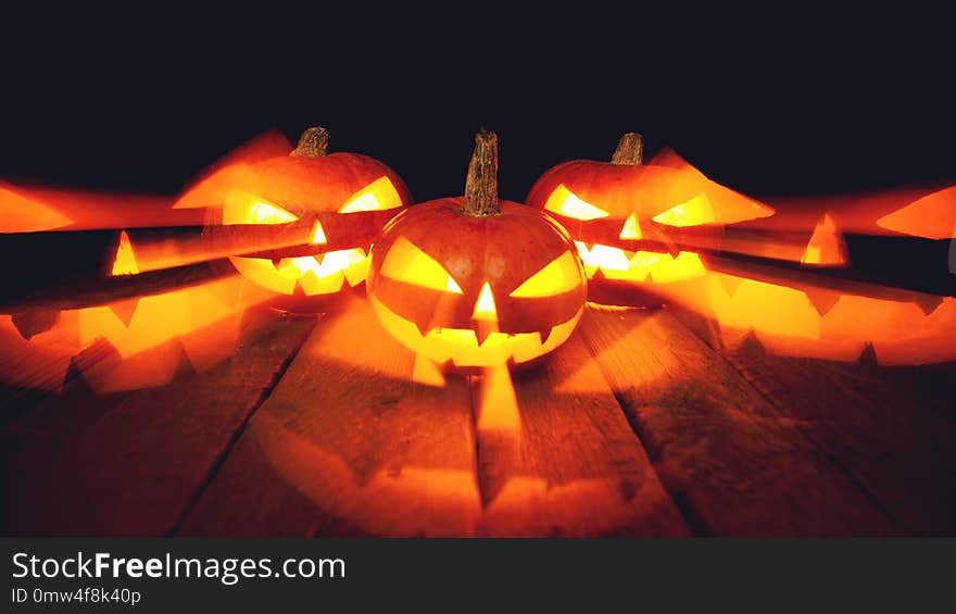 Three Halloween Pumpkins on black background