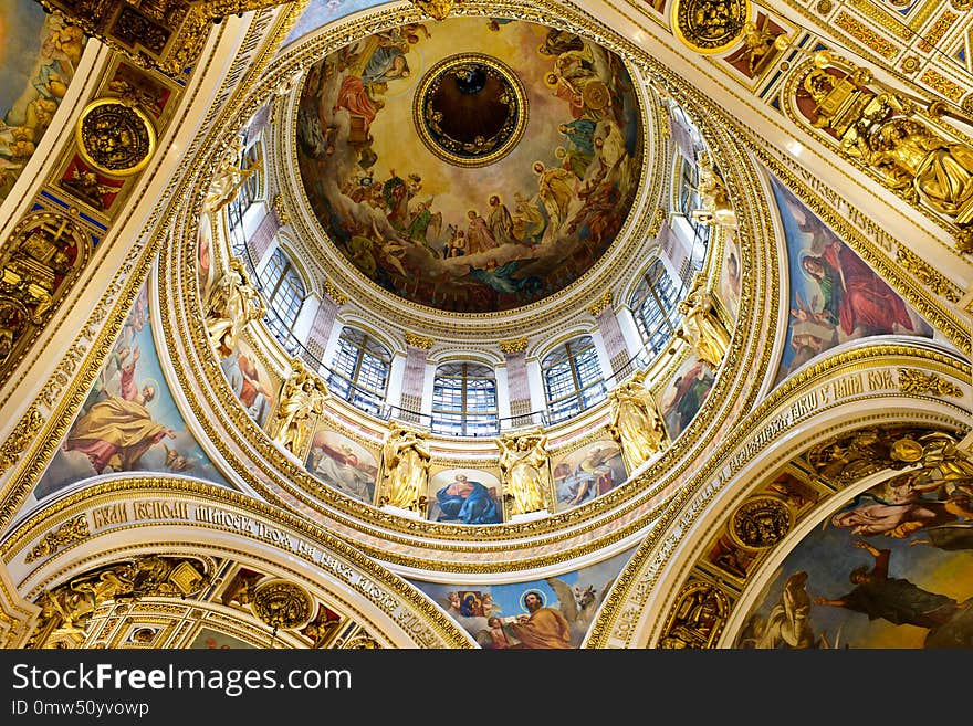 The dome of a cathedral in Russia is splendid and magnificent. The delicate embossment is golden and attractive. The religious atmosphere is superb.