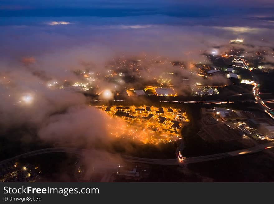 Night long exposure of suburban houses and roads on a cloudy and hazy night