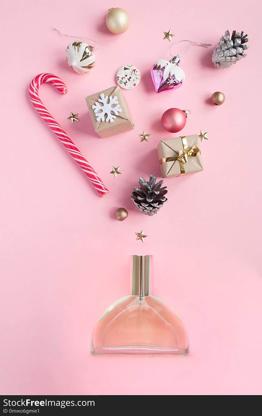 Perfume bottle different christmas decoration on pink background. Open perfume concept. Flat lay. Perfume bottle different christmas decoration on pink background. Open perfume concept. Flat lay.