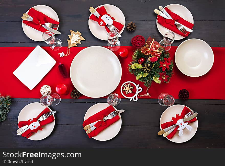 Prepared Christmas table for serving dishes. Scenery, spruce branches, tinsel and candles. Top view