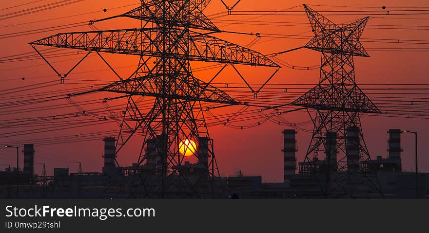 High voltage electricity pole at sunset. energy concept, industrial photo