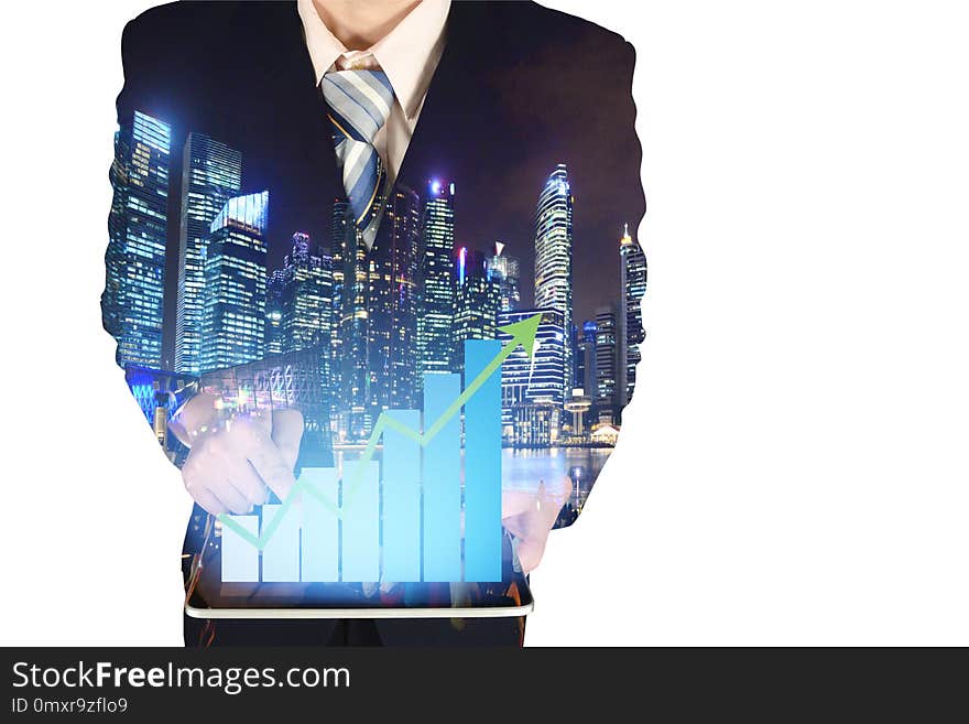 Double exposure of businessman using tablet with growth financial graph chart and building background.